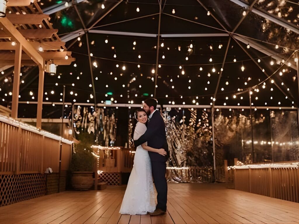 Outdoor wedding couple under lights