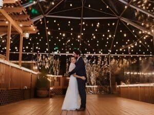 Outdoor wedding couple under lights
