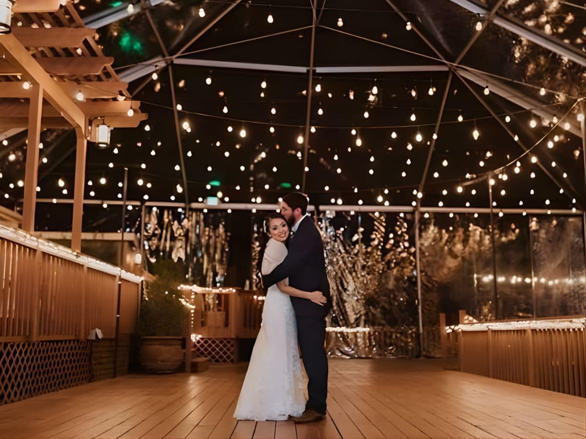 Outdoor wedding couple under lights