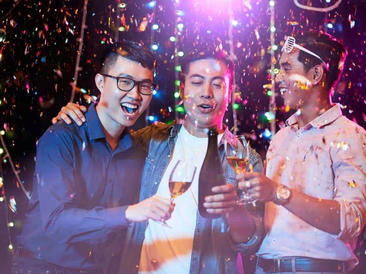 Group of friends toasting and celebrating during a bachelor party.