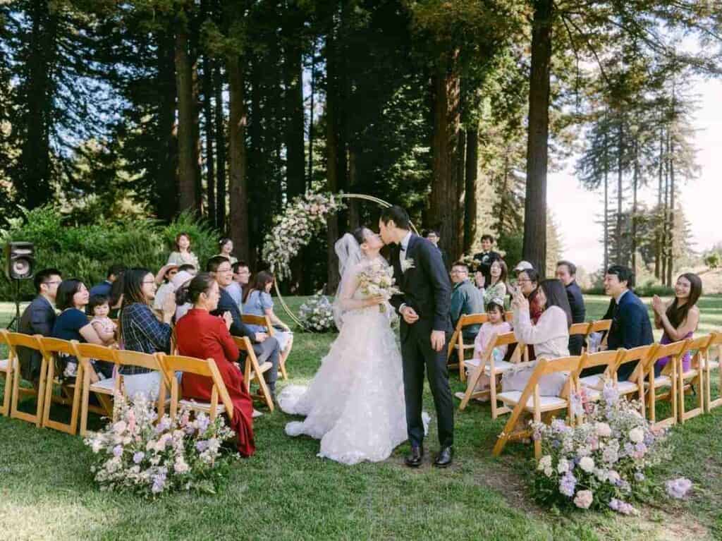 Bride and groom kissing after exchanging vows.