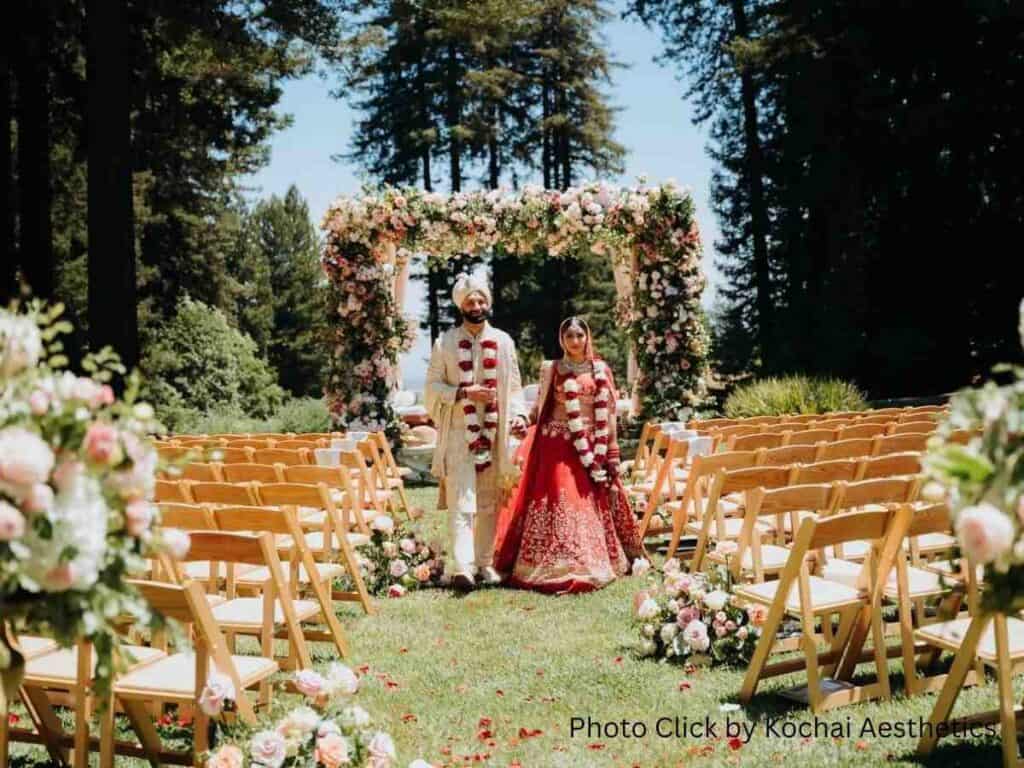 Bride and groom at a floral outdoor wedding ceremony