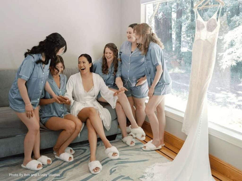 Bride and bridesmaids sharing laughs before wedding