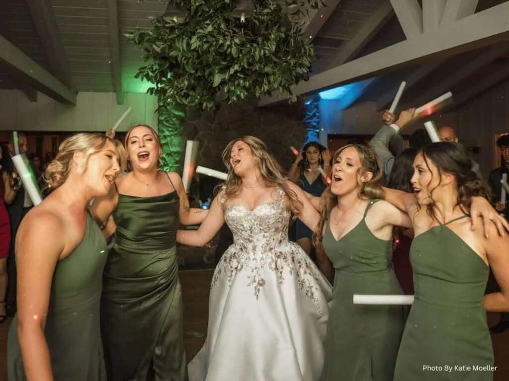 Bride and bridesmaids singing during reception
