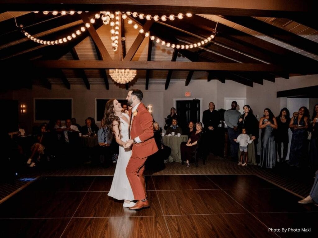 Bride and groom dancing at indoor wedding reception